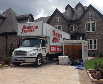 A Motivated Movers Atlanta truck is parked in front of a large house, ready to serve.