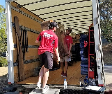 Two movers from the Huntsville team working hard to help their customers.